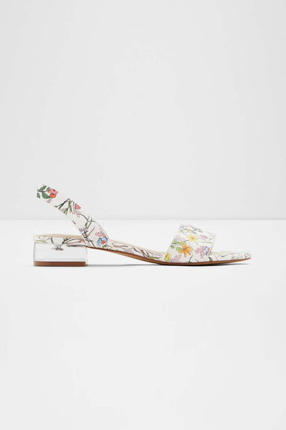 White floral sandals with low block heel and ankle slingback strap, side profile