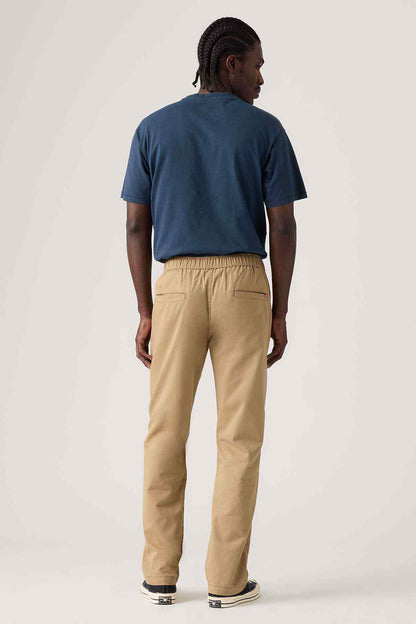 Tan jogger pants from behind with elastic waistband and tapered legs
