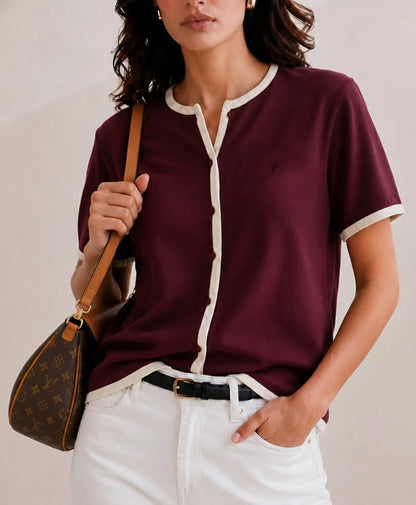 Burgundy fitted henley T-shirt with white collar trim, short sleeves, and button placket