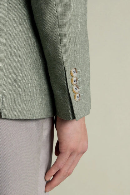 Green blazer cuff with button closure and textured fabric