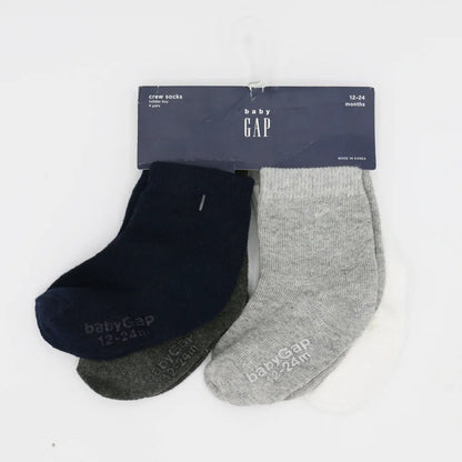Baby crew socks in navy and heather gray, with tags on packaging