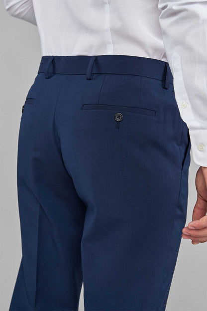 Men's navy blue dress trousers close-up of waistband button and front pocket