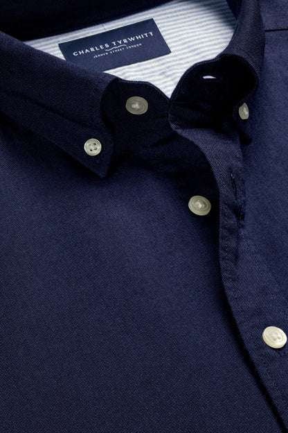 Men's dark blue dress shirt, striped inner collar, button placket close-up