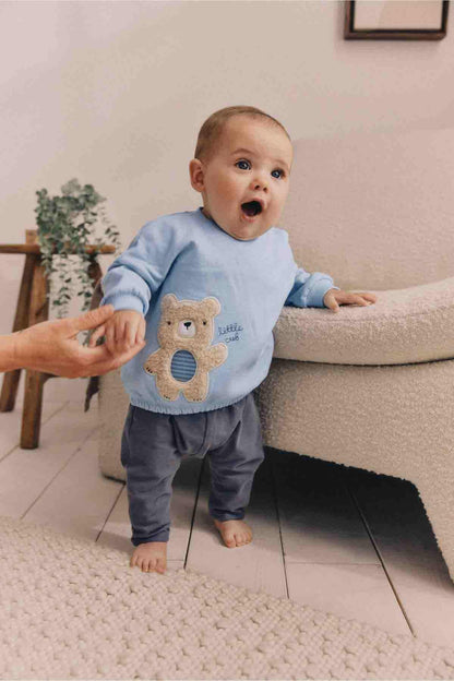 Light blue long-sleeve baby sweatshirt with teddy bear applique on the front