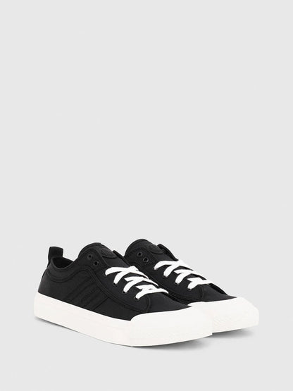 Black Diesel low-top sneakers, side view with white laces and thick white sole