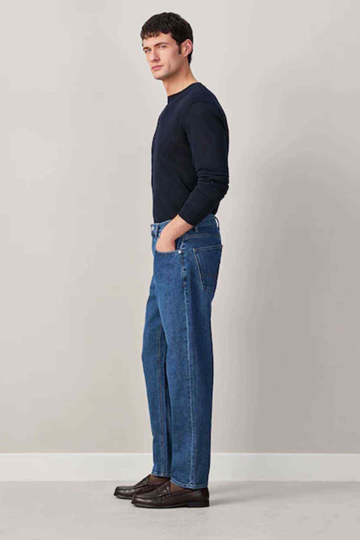 Men's mid-blue denim jeans, side view, straight fit with button fly
