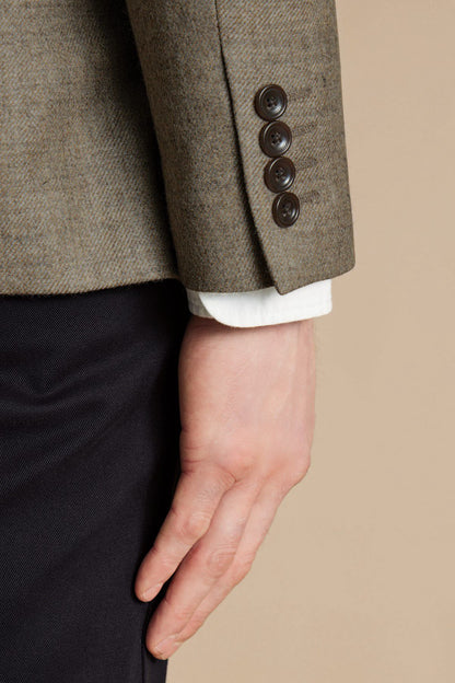 Charles Tyrwhitt gray blazer sleeve cuff with two dark buttons over white shirt