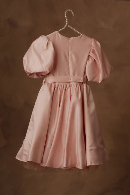 Pink dress with puff sleeves, back button placket, gathered waist bow and flared skirt.