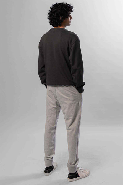 Levi's logo crewneck sweatshirt and light grey tapered jogger pants, back view