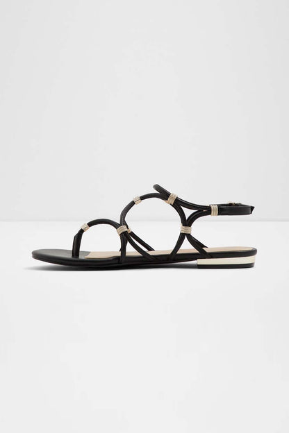 Black thong-style flat sandal with crisscross straps and toe loop