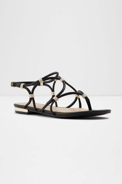Black flat sandal with crisscross straps, gold-tone details, open toe