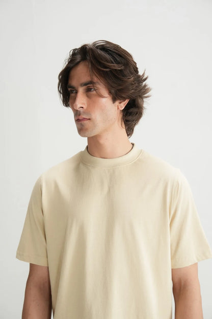 Beige short-sleeve crewneck T-shirt close-up on male model