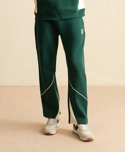 Fitted dark green track pants with white piping and small side logo