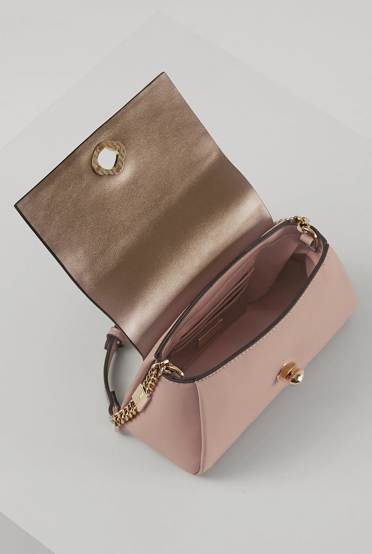 Pink flap shoulder bag with open interior view and gold chain strap