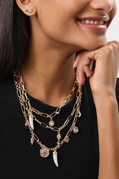 Gold-tone multi-layer necklace with dangling charms and coin pendants