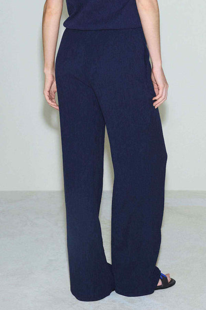 Navy wide-leg trousers with relaxed fit and side pockets, ankle length