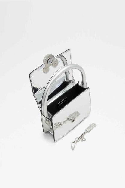 ALDO light silver mini handbag open, showing chain strap and bow charm accessory
