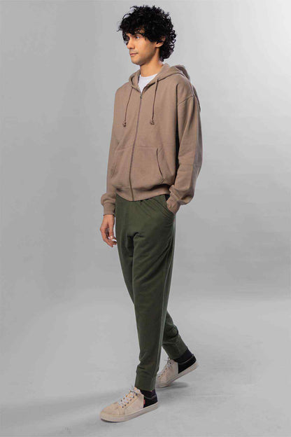 Levi's taupe zip hoodie and green jogger pants, side profile