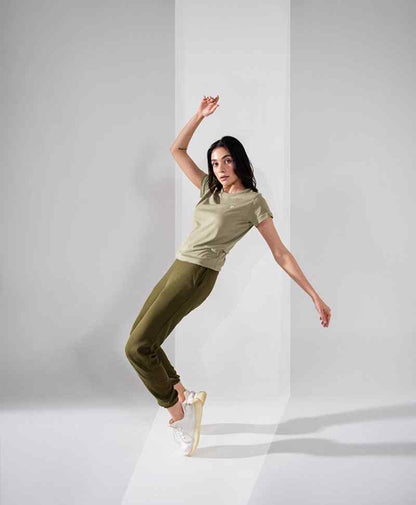 Fitted olive T-shirt and jogger pants, full-body pose leaning upward