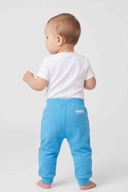 Blue baby jogger pants, back view with Smurfs logo patch