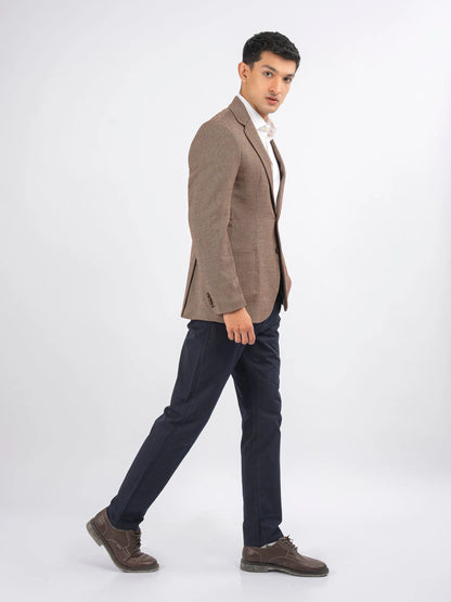 Men's brown blazer side view with notch lapels and buttoned single-breasted front