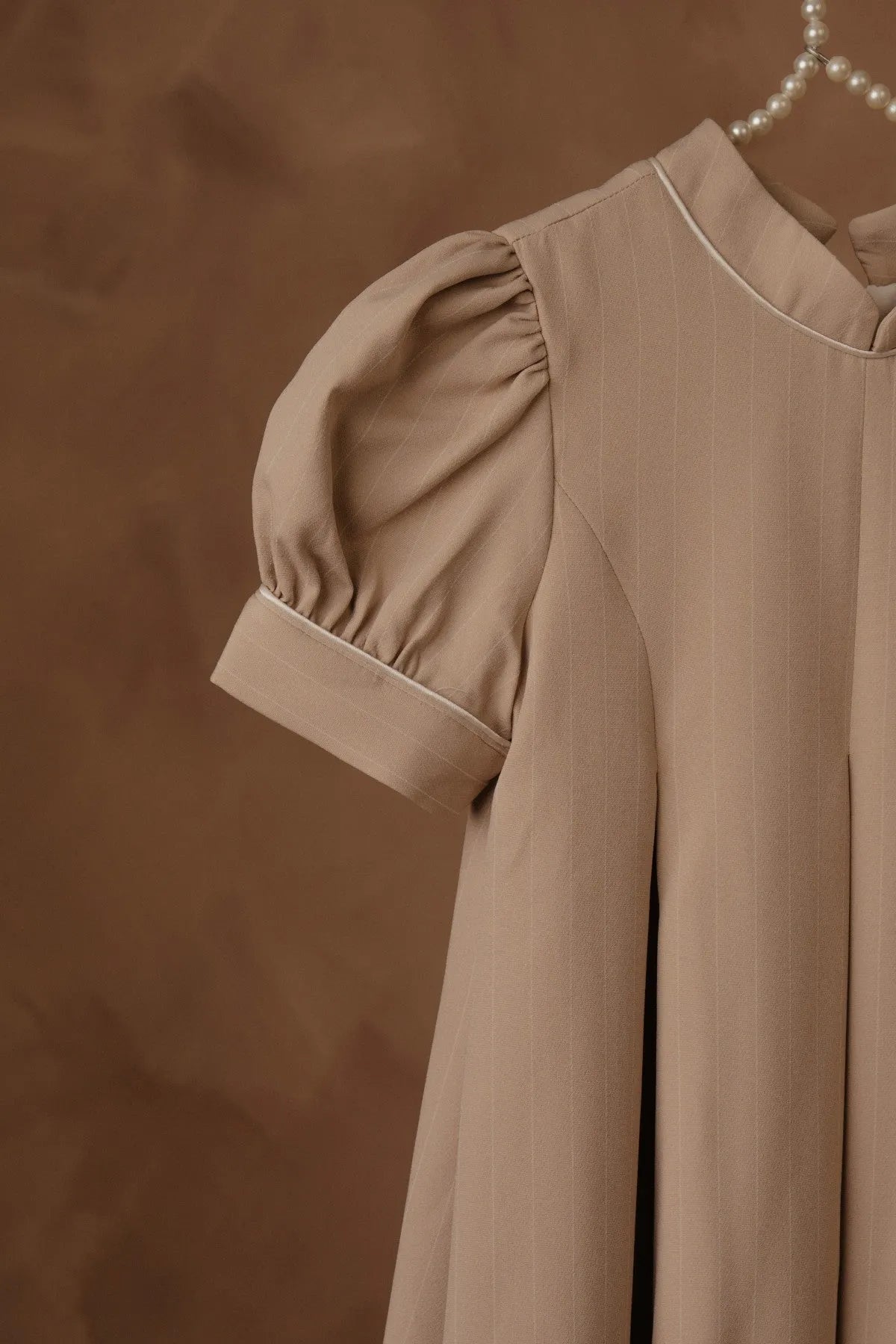 Stone dress detail: puff sleeve with gathered shoulder and vertical pleats