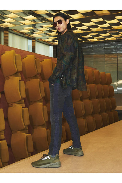 Diesel green sneakers worn with camouflage trousers