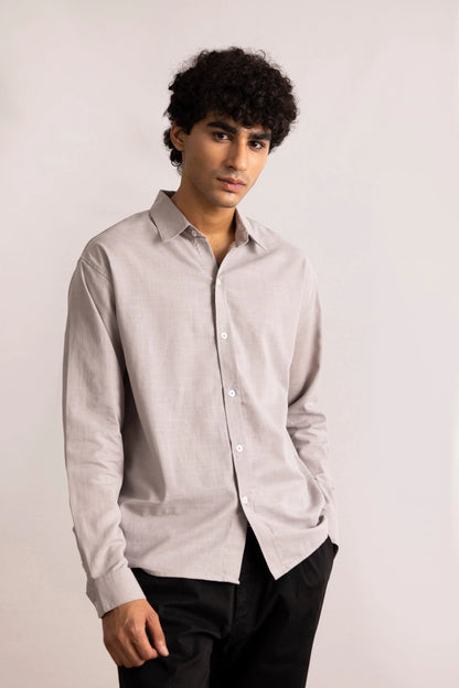 Grey button-up shirt on model, long sleeves, button front, pointed collar