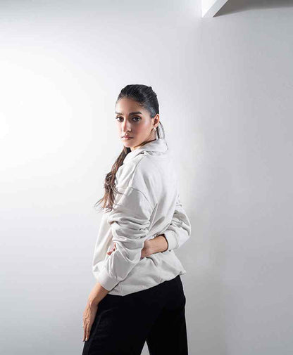 Fitted off-white hoodie with hood and long sleeves, side view