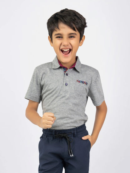 Kids heather gray polo shirt with maroon collar, button placket, chest logo; navy pants
