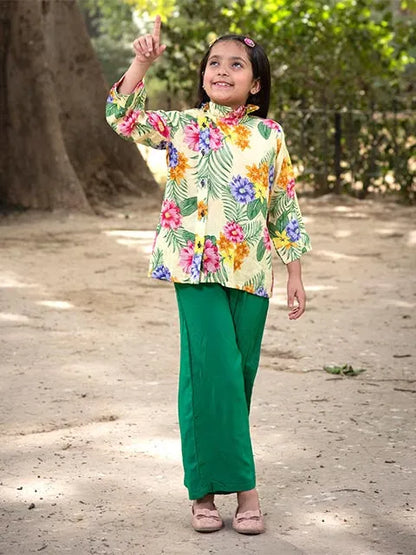 Kids floral high-neck long-sleeve top with green pants, waving