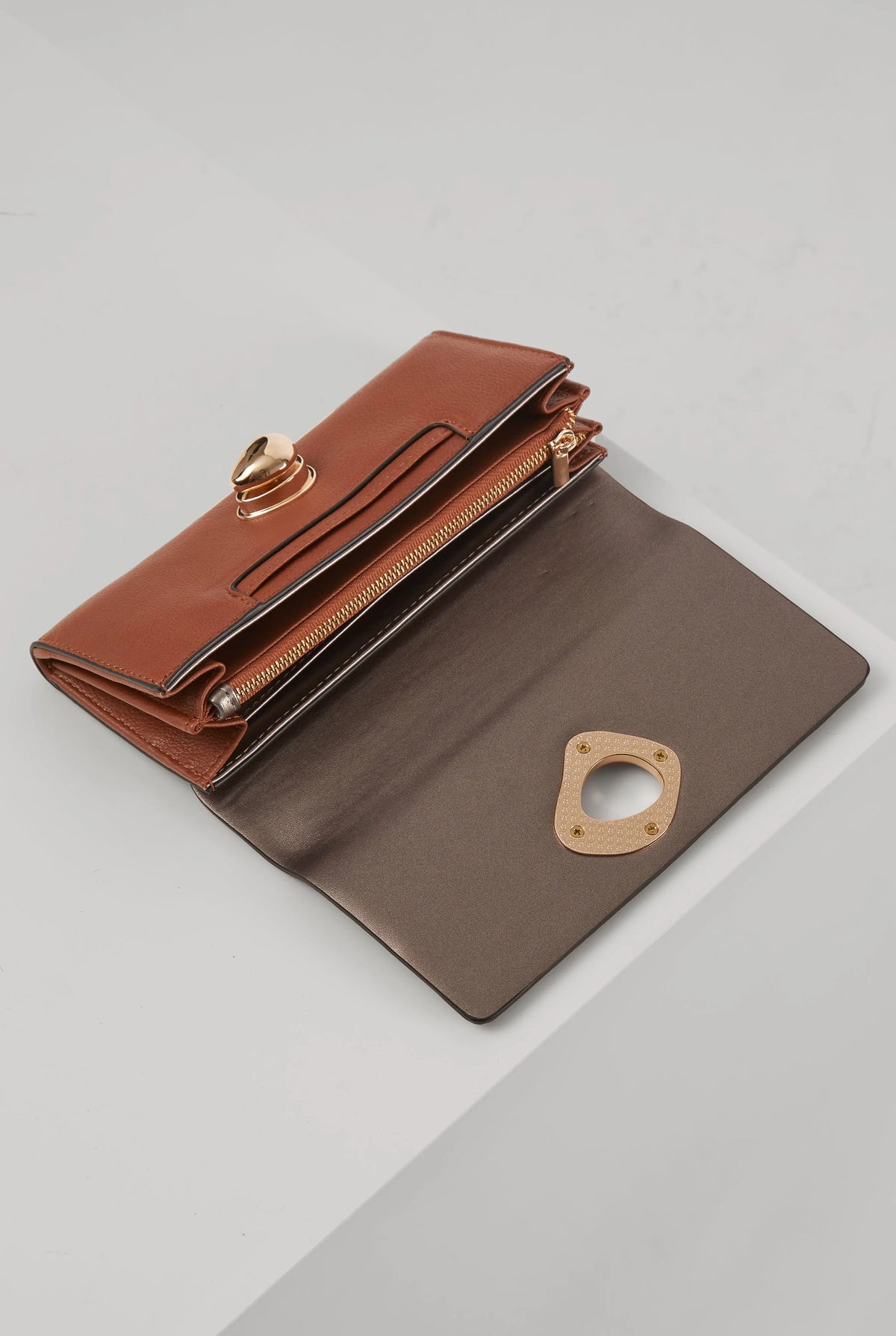 Brown wallet open to show zippered interior and gold-tone hardware