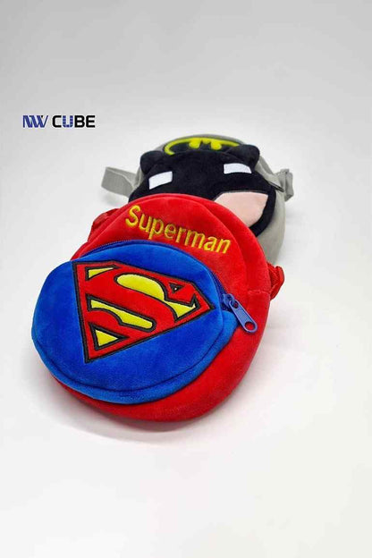 Round plush Superman crossbody pouch with red logo front and blue strap; another pouch behind