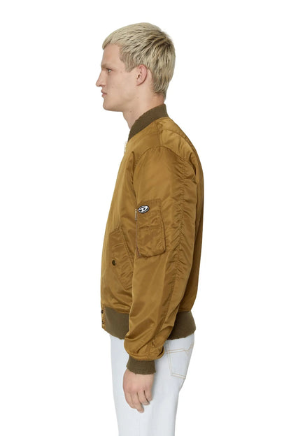 Tan bomber jacket side view with shoulder pocket and ribbed knit cuffs