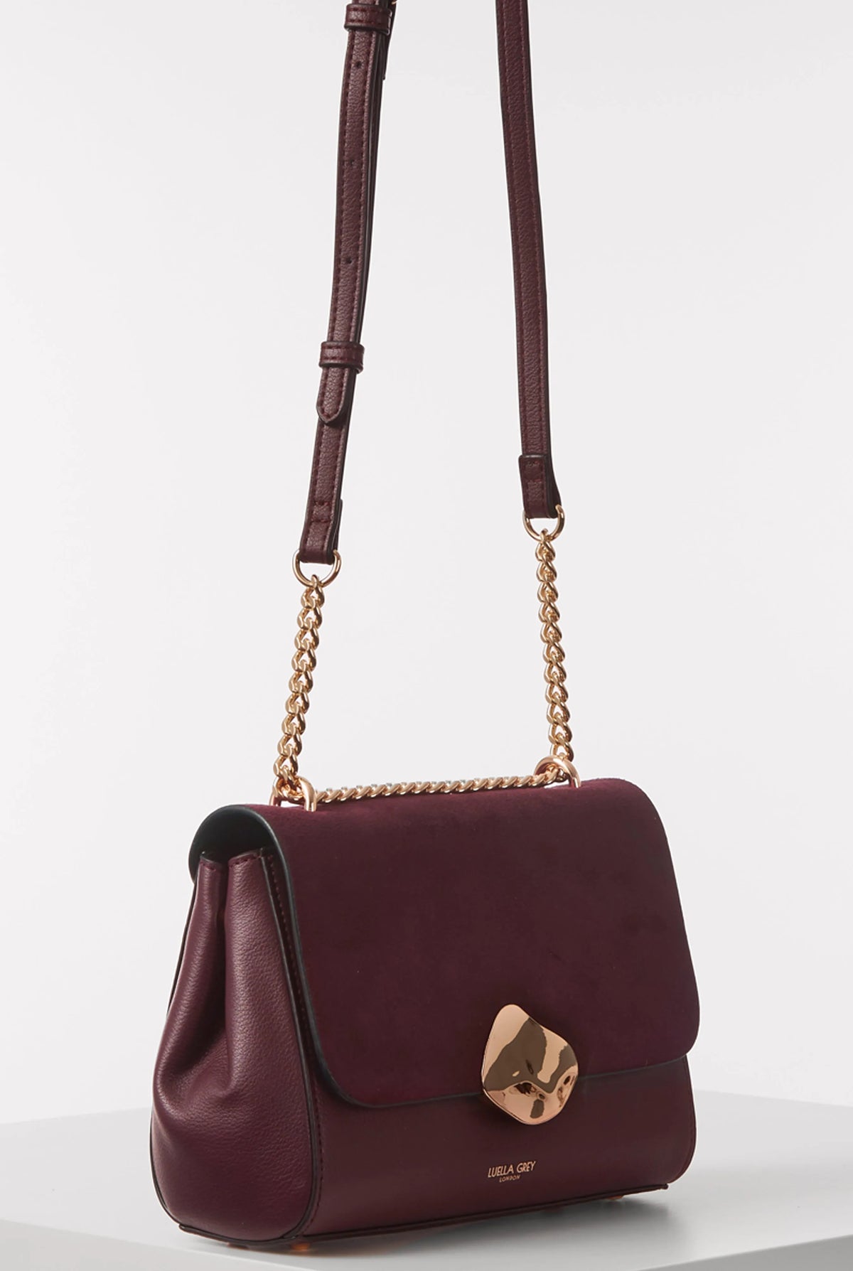Burgundy leather shoulder bag with top handle straps, gold chain, front flap
