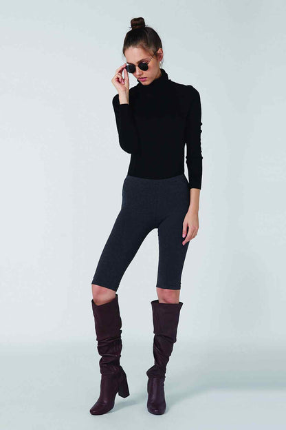 Black long-sleeve turtleneck top with dark gray capri leggings