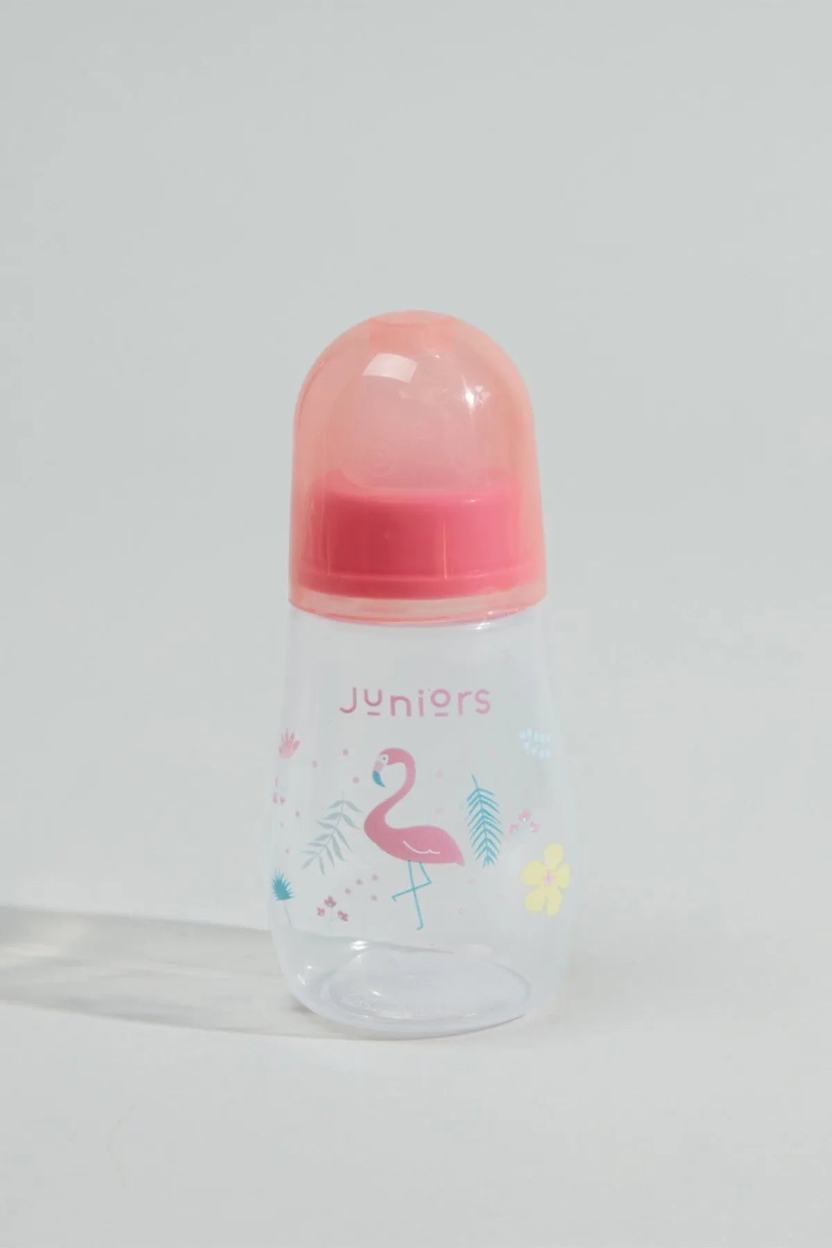 Baby bottle with pink cap and flamingo print, 'Juniors' on front