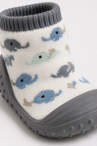 Patterned baby socks with whale print, gray ribbed cuff, grippy sole