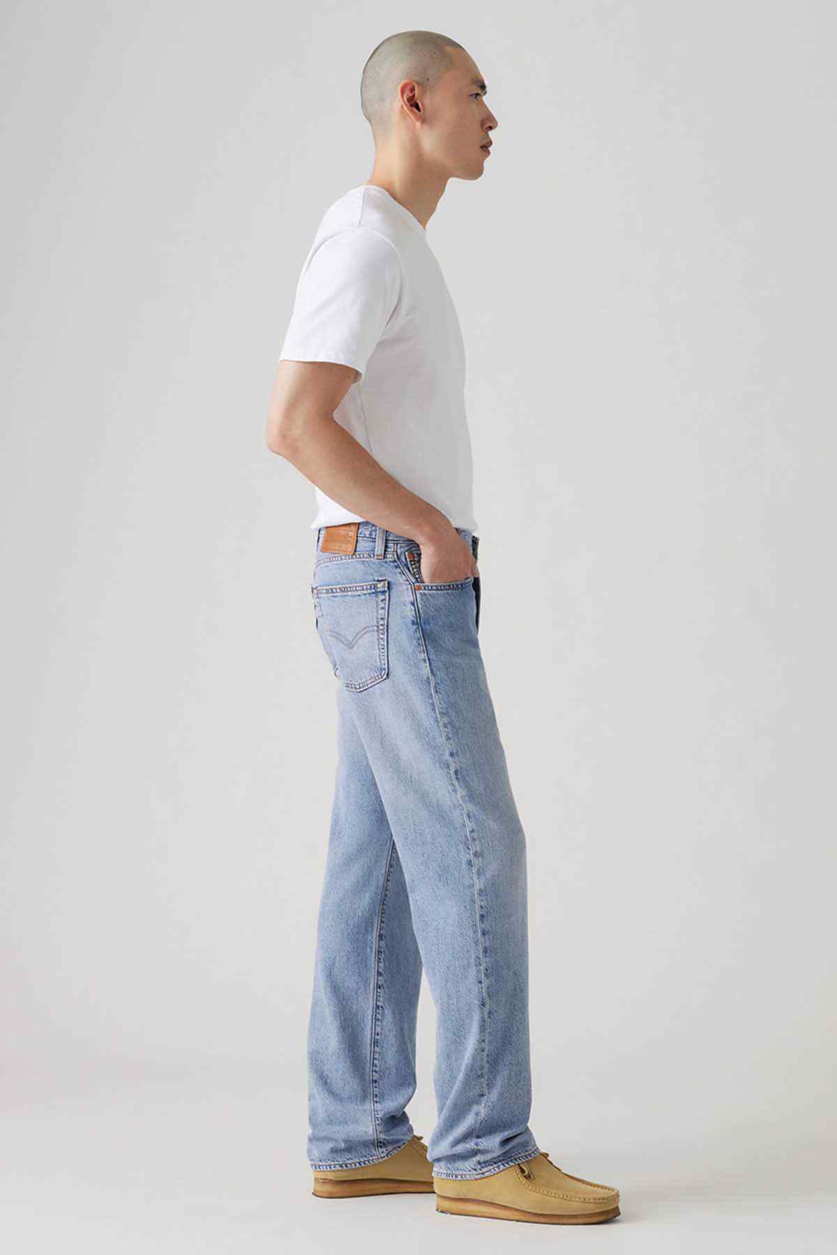 Light indigo denim jeans, side view with straight leg seams and belt loops