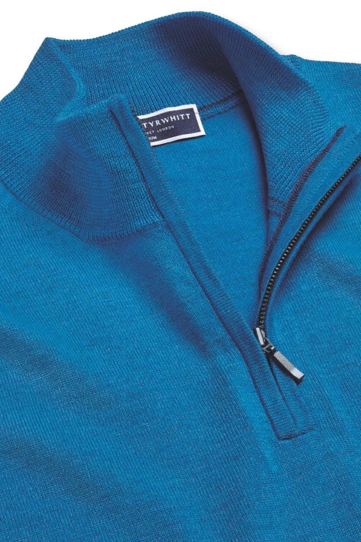 Blue knit quarter-zip sweater close-up of zip pull and neck label