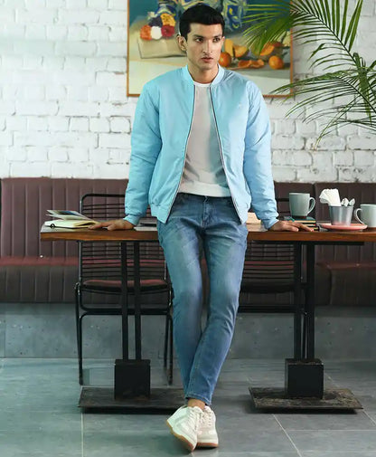 Light blue fitted bomber jacket with zipper and stand collar, over a white tee