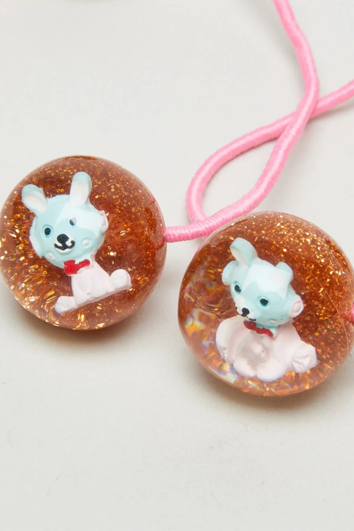 Glitter bead hair ties with pink elastic, blue bunny face and white outfit charm