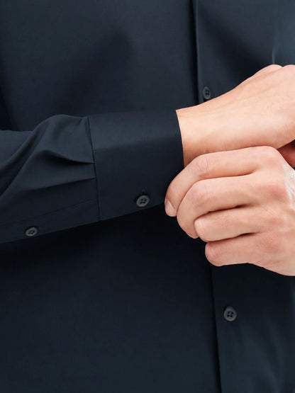 Dark navy cotton dress shirt cuff and buttoned sleeve placket detail