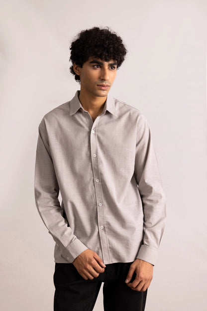 Grey button-up shirt on model, long sleeves, button front, pointed collar