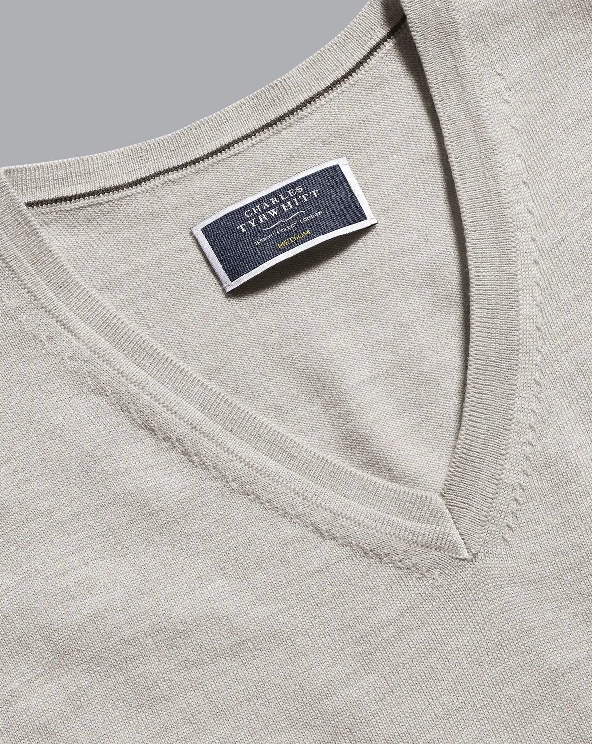 Grey V-neck knit sweater label at neckline