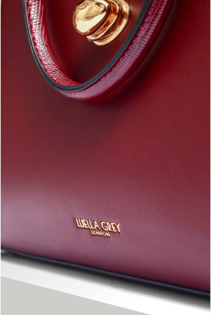 Berry tote handbag close-up of logo and gold-tone clasp on front