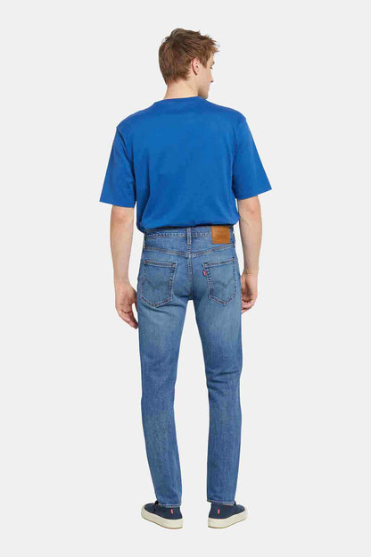 Blue crewneck T-shirt and blue jeans, back view, straight legs