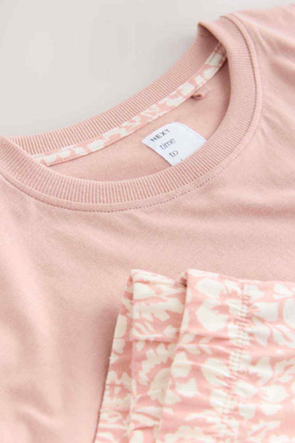 Pink T-shirt neckline with inner label and patterned pocket detail