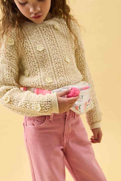 Kids unicorn waist pouch with rainbow zipper and pink pom pom, held by child