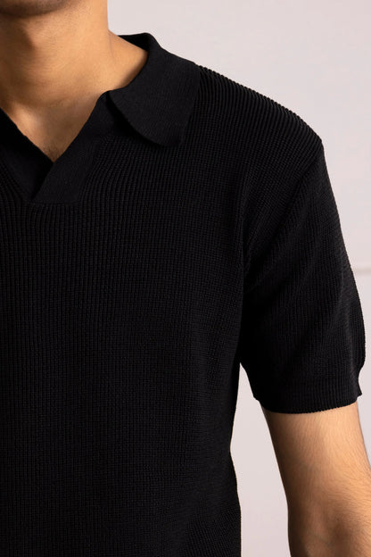 Black polo shirt close-up with ribbed knit texture and collared neckline